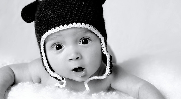 beautiful baby in silly hat bw portrait